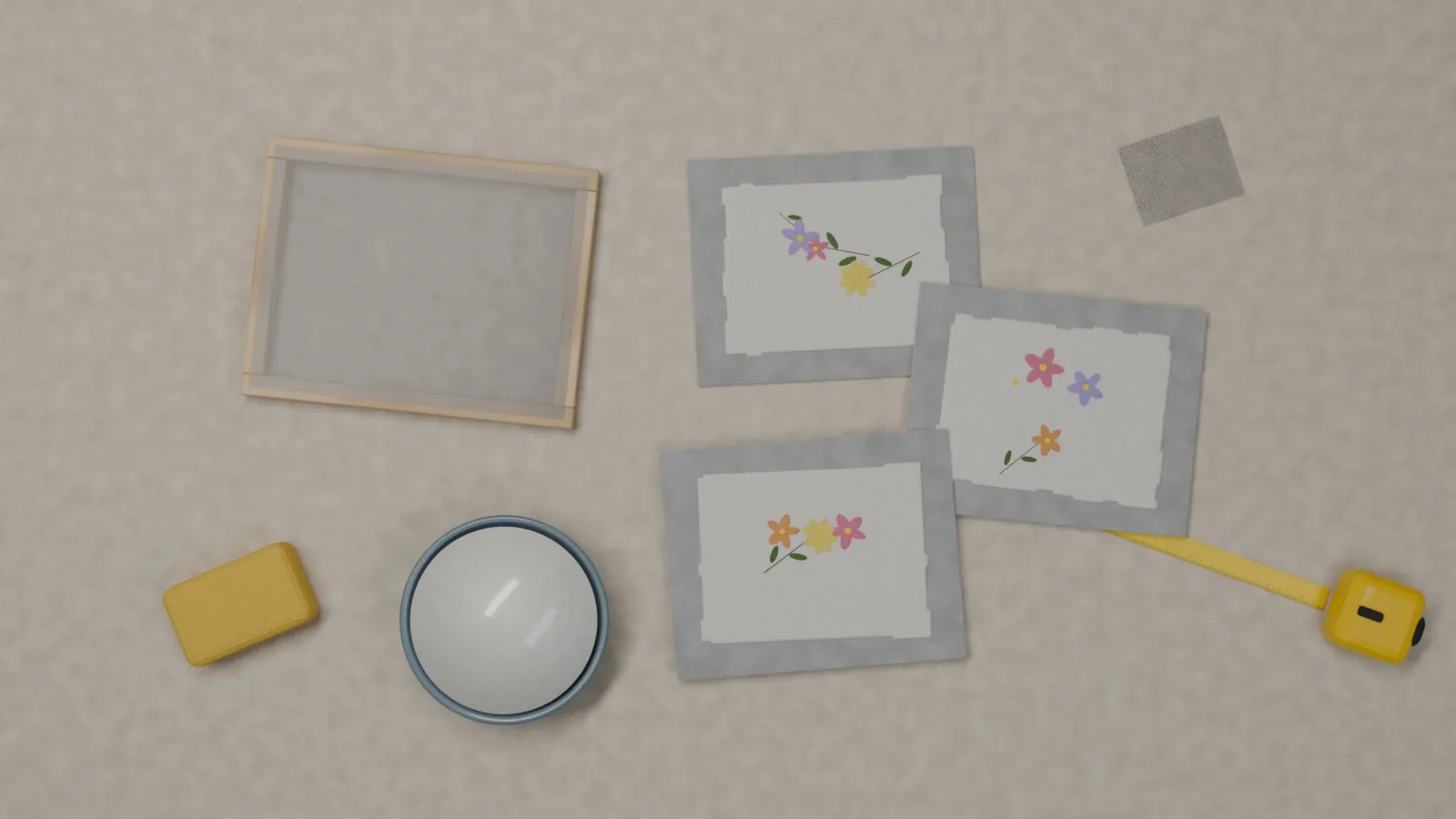 Schöpfrahmen mit Drahtgeflecht, handgeschöpfte Papierbögen mit Blüten, Schwamm, Schale und Maßband